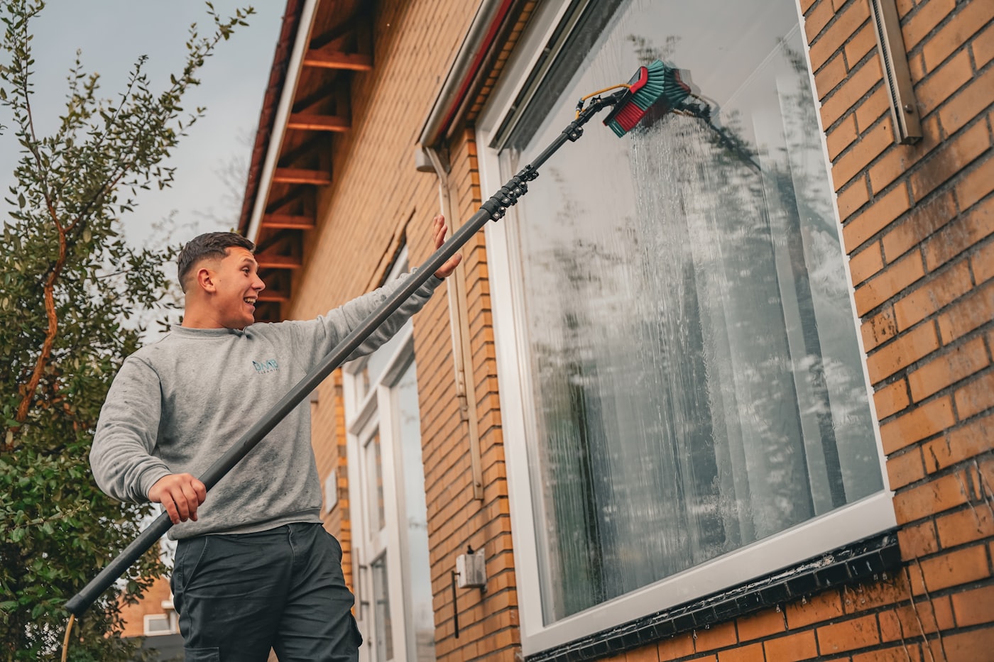 Gutter cleaning in progress on a residential roofline