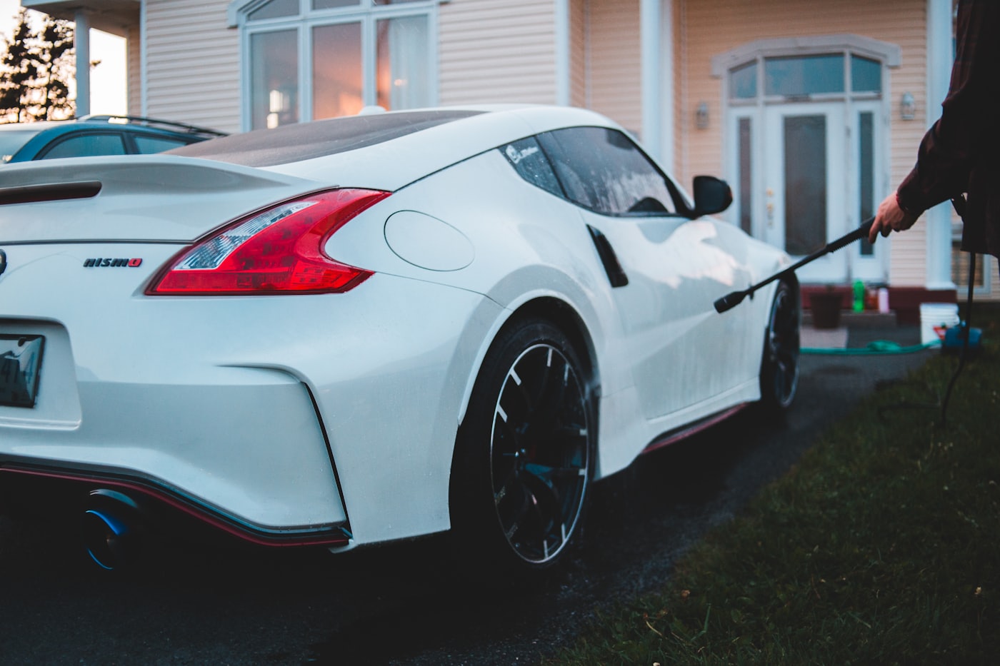 Car being washed and prepared in a residential driveway